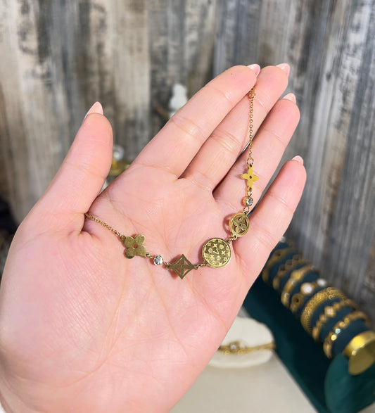 Anti-Tarnish Waterproof Clover Charm Bracelet - Gold Coin Medallion Chain Bracelet worn on a hand showing its elegant design.