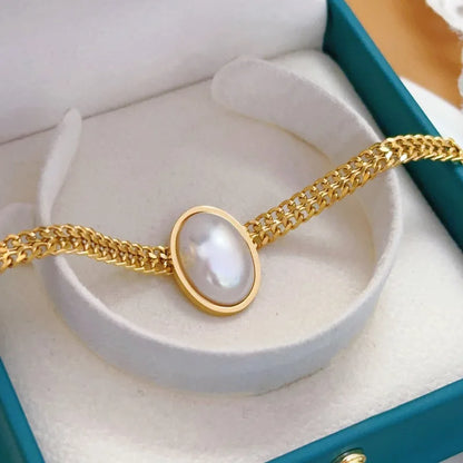 Anti-Tarnish Waterproof Pearl Bracelet - Gold Chain with Oval Pearl Centerpiece displayed in elegant packaging.