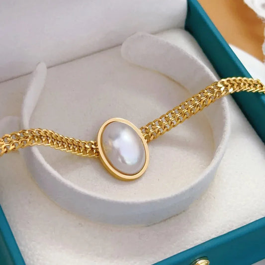 Anti-Tarnish Waterproof Pearl Bracelet - Gold Chain with Oval Pearl Centerpiece displayed in elegant packaging.